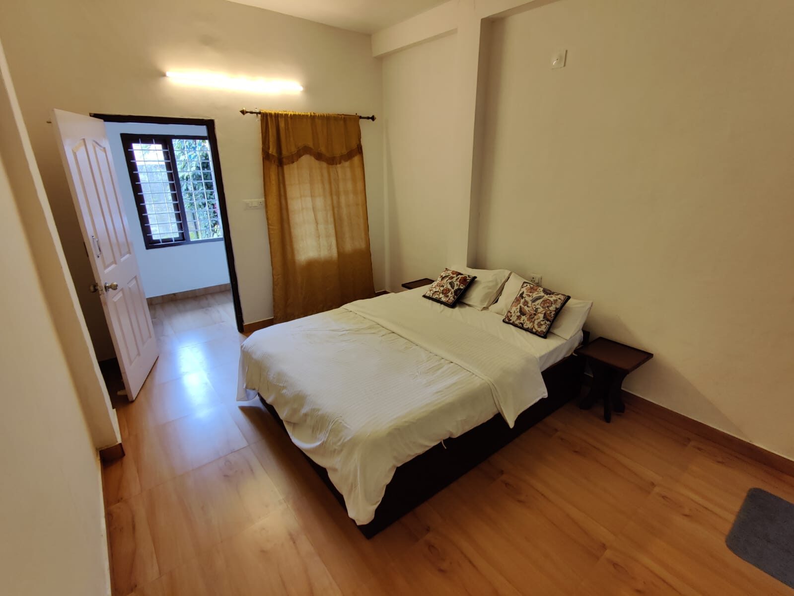 Bedroom with a wooden bed and curtains