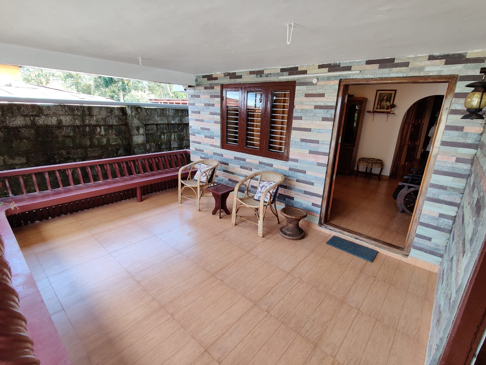 Porch with a bench seat and a stone-walled entrance